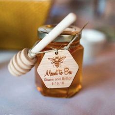 a jar of honey with a stick in it