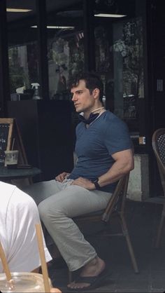 a man sitting at an outdoor cafe table