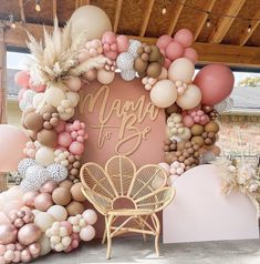 a pink and gold balloon arch with the words happy birthday on it, surrounded by balloons