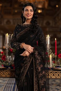 Elegant Pakistani Wedding Dress in Classic Black Shade Net Saree features handcrafted adda embellishments, thread embroidery, and sequins, hanging drapes and cut-out details on the sleeves, and handcrafted tassels on the back. Detailed Description: SKU: WB418 Detailing: Embroidery, Motifs, Naqshi, Sequins, Tilla Color: Black Fabric: Net, Tissue, Cotton Silk Design: Fully Embellished Dress with Embroidery, Goldwork Event: Bridal wear, Wedding Black Net Saree, Embroidery Goldwork, Hanging Drapes, Wedding Dresses Pakistani, Hijabi Brides, Silk Design, Desi Wedding Dresses, Traditional Dresses Designs, Pakistani Wedding Outfits