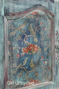 an old painted door with birds and flowers on it