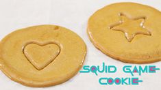 two cookies with icing in the shape of a heart and a star on top