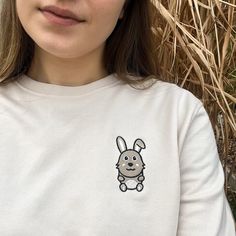 Add a touch of charm to your wardrobe with our Rabbit Embroidered Crewneck Sweatshirt. Made from a soft cotton blend, this relaxed fit pullover features a delightful rabbit embroidery, capturing the essence of playful and cute style. The unisex design makes it perfect for everyone, offering a stylish and comfortable option for any casual occasion. Whether you're lounging at home or heading out, this sweatshirt brings warmth and cuteness to your look. Cute White Sweatshirt For Everyday, Cute Crew Neck Sweatshirt For Everyday, Cute Cotton Sweatshirt For Everyday, Cute Cotton Everyday Sweatshirt, Cute Everyday Cotton Sweatshirt, Lover Style, Rabbit Embroidery, Embroidered Crewneck, Unisex Design