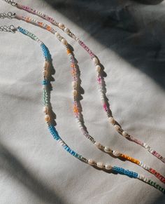 These coastal collection necklaces come in pink, multi sunset, and blue :) Perfect for summer and the beach! 20% of profits made will be donated to local women's health organizations. Coastal Grandma Jewelry, Cute Beachy Jewelry, Beaded Beach Jewelry, Colorful Letter Beads Necklace For Summer, Colorful Summer Necklaces With Letter Beads, Colorful Summer Letter Beads Necklace, Pink Strand Necklaces For Summer, Handmade Colorful Necklaces For Vacation, Pink Beach Necklace For Summer