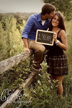 a man and woman holding a sign that says 1 year on their anniversary watch as you grow old together love this idea wish