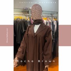 Elevate your style with our mocha brown coat abaya, crafted from premium coat fabric and featuring luxurious collars. This exquisite piece showcases intricate handwork detailing, adding a touch of elegance to your wardrobe. Complete with a matching hijab, it offers a sophisticated and cohesive look. Elegant Long Abaya For Workwear, Elegant Formal Abaya For Fall, Elegant Long Thobe For Fall, Elegant Brown Thobe For Eid, Elegant Long Sleeve Brown Abaya, Elegant Long Brown Abaya, Elegant Long Winter Abaya, Elegant Brown Long Sleeve Thobe, Luxury Long Sleeve Abaya For Eid