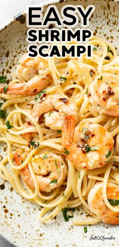 shrimp scampp pasta in a white bowl with parsley on top