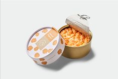 an open tin can with macaroni and cheese in it on a white background