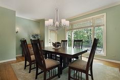 a dining room table with chairs and a chandelier