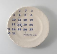 a white plate with blue numbers on it and the words, from this day to next