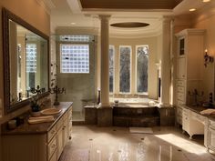 a large bathroom with two sinks and a bathtub in the middle of the room