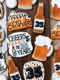 decorated cookies with beer and happy birthday written on them are laid out on a table