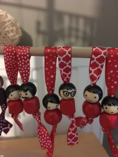 some red and white ornaments hanging from a string