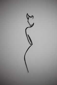 a metal sculpture with a woman's head on it