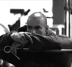 a man sitting in a chair with his arms crossed