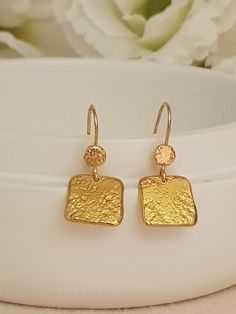 18K Gold  handmade hammered square earrings dangling from 18K solid Gold.Lightweight and comfy to wear these earrings are great sparkle for everyday!• They will make a great gift! • The total length of the earrings is 33 mm/ 1.4" approx from top to bottom. • Weight:4 Grams• Material: 18k Gold •  18k solid gold thick• Pendants Highet 34mm, Width 13mm. * Ear wires are gold  • All earrings with French ear wires come with silicon backings for extra protection. SKU EG055Have questions? Send me a conv Elegant Gold Nugget Earrings, Gold Nugget Earrings As Gift, Gold Square Earrings For Anniversary, Gold Hammered Rectangular Earrings, Dainty Hand Forged Gold Earrings, Textured Gold Earrings, Thick Gold Ring, Gifts For Anniversary, Unique Gifts For Sister