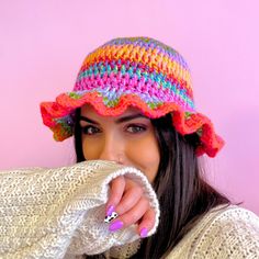 a woman wearing a multicolored hat covering her face