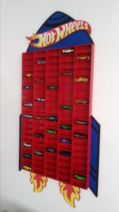 a wall mounted toy storage unit with hot wheels on it