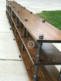 a row of wooden benches sitting on top of a sidewalk