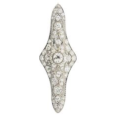 A classic Edwardian piece, circa 1915, featuring 2.55 carats of European-cut diamonds. They are set around the 3-dimensional piece decorated with filigree and garland style motifs typical of the Edwardian era. Made in platinum and finished with a gold pin clip. Length: 2.1 inches Weight: 7.3 grams The Edwardian Era, Edwardian Era, Pin Brooch, Diamonds