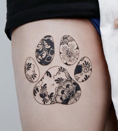 a woman's thigh with an animal paw tattoo on it