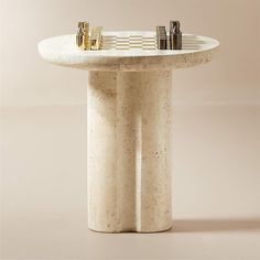 a marble table with three gold - plated objects on it's pedestals