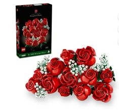 a bouquet of red roses in front of a box