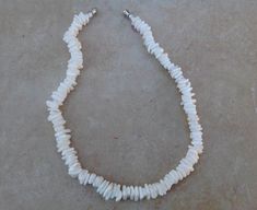 "Classic lightly polished white puka shell necklace. MEASUREMENT- 14\" - 18\" long. This is for kids only or for teen with small neck size. Puka shells are the broken off crowns of cone shells that have been tossed in the surf and create a unique, natural bead. Each shell is unique and vary slightly in size and shape." Adjustable White Pearl Necklace With Natural Stones, White Spiritual Shell Necklace, White Spiritual Shell Necklace As A Gift, Spiritual White Shell Necklace Gift, Spiritual White Shell Necklace, White Shell Necklace With Natural Stones, White Adjustable Shell Necklace With Gemstone Beads, White Adjustable Shell Necklace Spiritual Style, White Adjustable Shell Necklace For Spiritual Wear