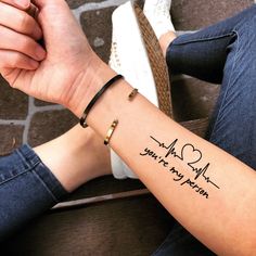 a woman's arm with a quote on it