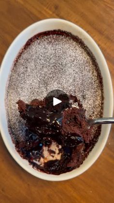 a bowl filled with pudding on top of a wooden table