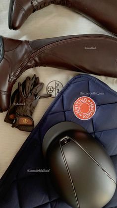 a pair of brown shoes and a computer mouse on top of a blue bag next to some other items