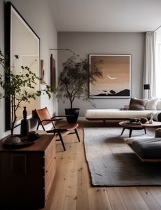 a living room filled with furniture and a painting hanging on the wall above it's windows