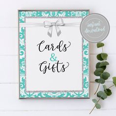 a card and gifts sign next to some eucalyptus leaves on a white background with the words cards & gifts