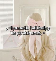 a girl with long blonde hair and a pink bow on her head is looking at herself in the mirror