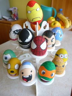 an assortment of angry birds and other cartoon character eggs on a table with bananas in the background