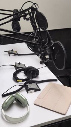 an electronic device sitting on top of a table next to headphones and ear buds