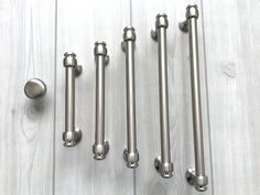 four different types of handles and knobs on a wooden floor