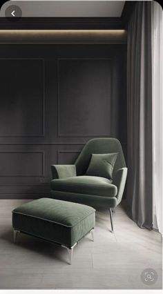 a green chair and footstool in front of a black wall with paneling