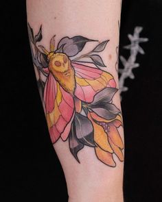 a woman's arm with a flower and bee tattoo on the left side of her arm