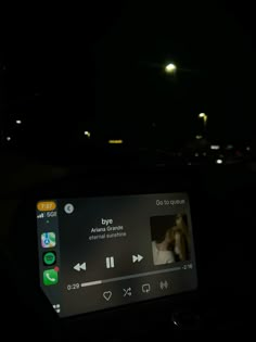 the dashboard of a car at night with an app on it's display screen