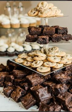 chocolate brownies and cookies are stacked on top of each other in front of desserts