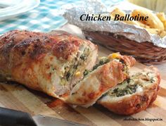 chicken stuffed with cheese and spinach on a cutting board next to a basket of fries