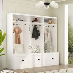 a living room with white furniture and an open window