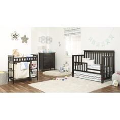 a baby's room with two cribs and a rug on the floor