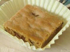 a piece of cake sitting on top of a white paper cupcake liner in a container