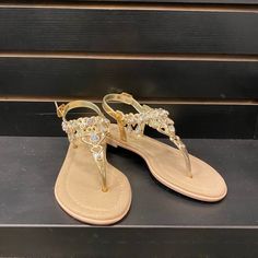 These Sandals Feature A Beautiful Heart Themed Decorated Strap, Cushioned Bottom, And Ankle Closure. Trendy Gold Synthetic Flip Flops, Gold Trendy Synthetic Flip Flops, Gold Ankle Strap Summer Sandals, Gold Ankle Strap Sandals For Summer, Gold T-strap Sandals For Spring Beach Outing, Gold Open Toe Synthetic Flip Flops, Adjustable Flat Slingback Sandals For Party, Gold Flat Heel Summer Sandals, Gold Flat Heel Sandals For Summer