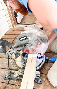 a man using a circular saw to cut wood