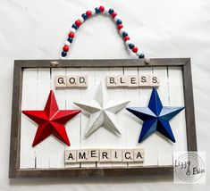 a wooden sign with three stars and the words god, bless, america