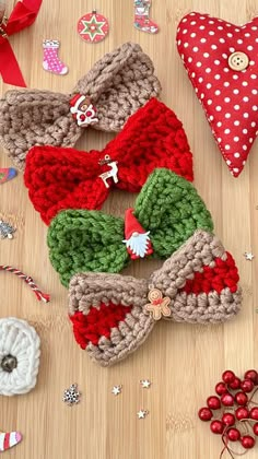 several crocheted bows are laying on a table next to christmas ornaments and decorations