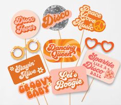 an assortment of orange and pink photo props with the words disco, dancing queen, let's do it all